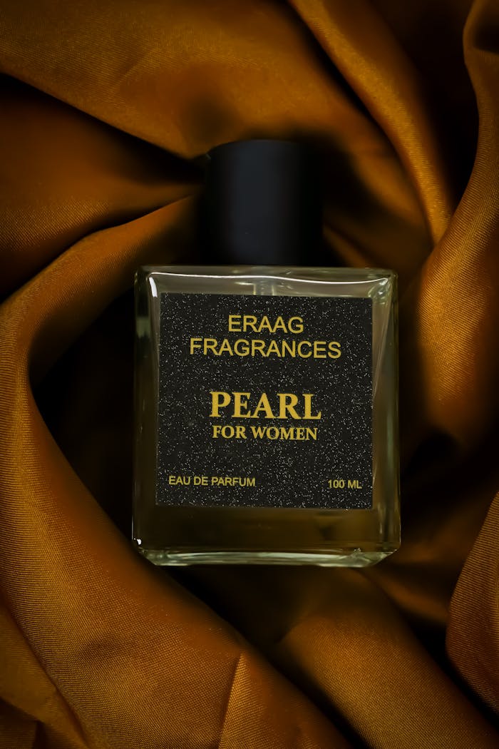 Elegant Eau de Parfum for women by Eraag Fragrances on rich satin fabric.